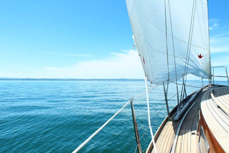 white boat on sea under blue sky during daytime